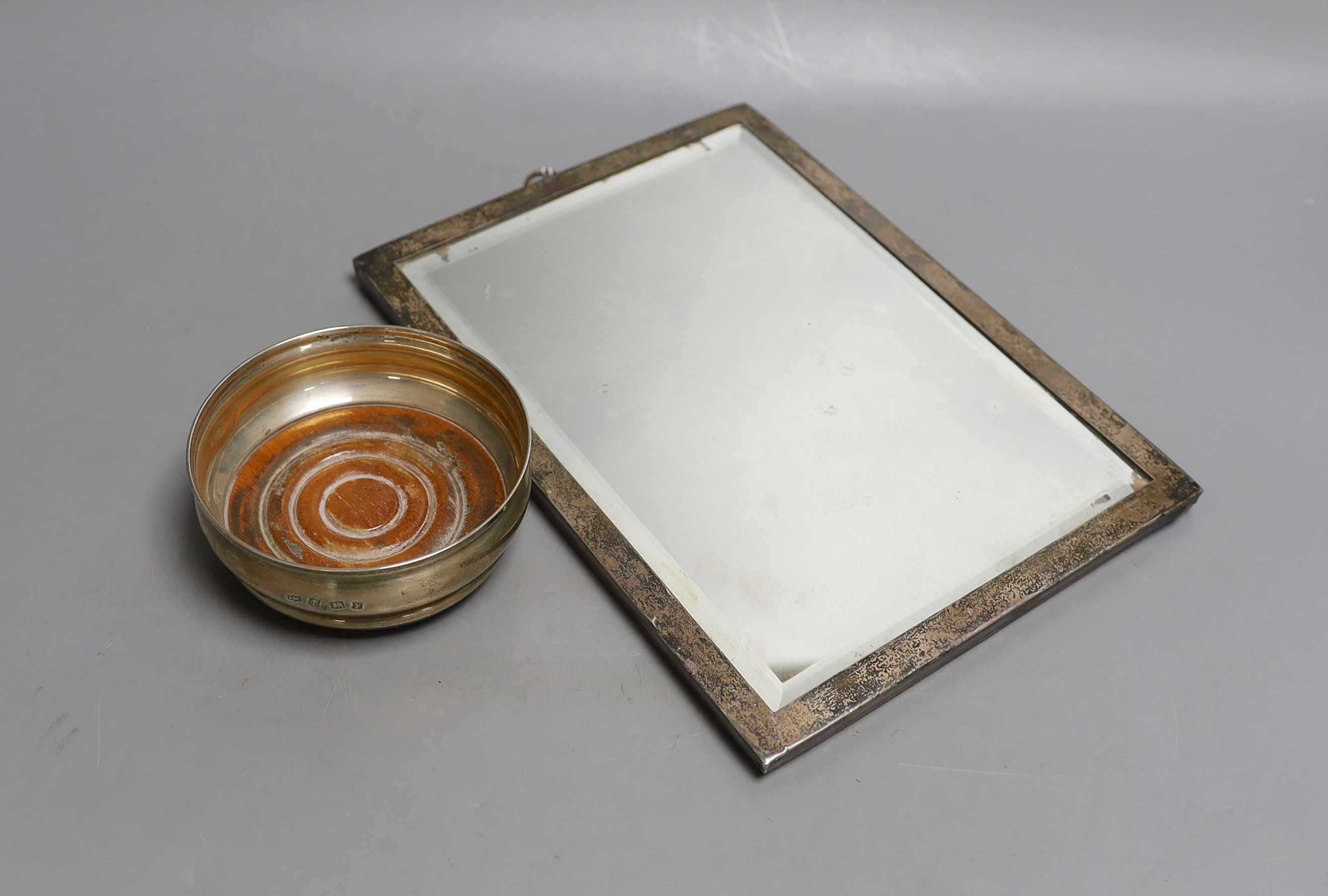 A George V silver mounted photograph frame, 25.5cm and a modern silver wine coaster, 10.3cm.